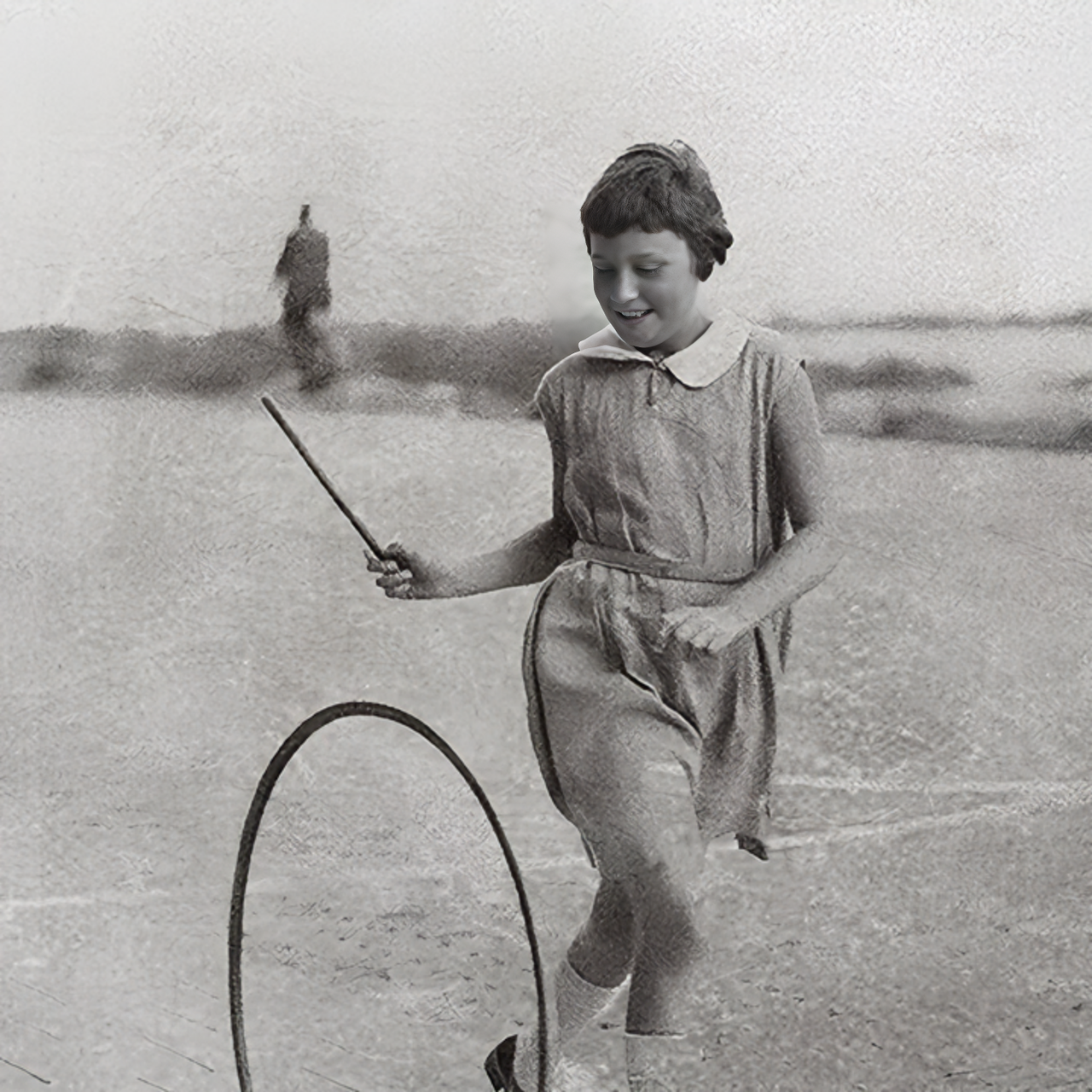 An old photo of a girl playing with hoop