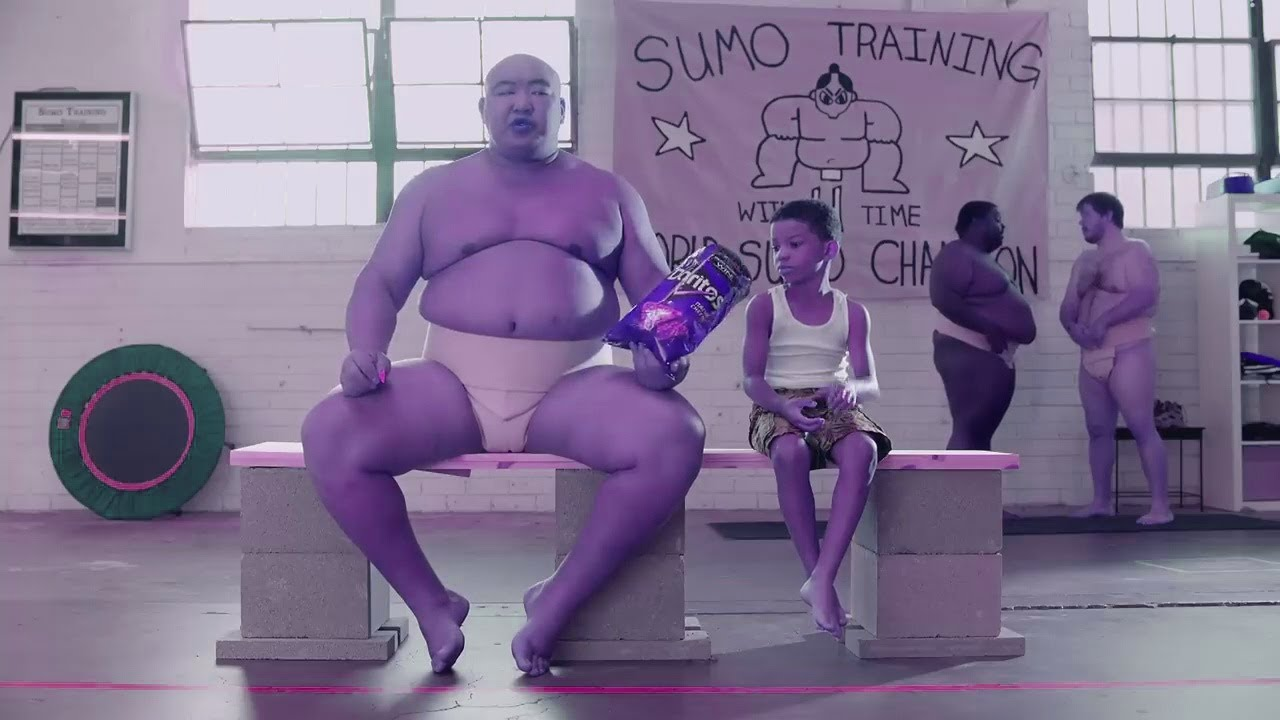 Boy and sumo wrestler chasing over Doritos - the most successful YouTube ad